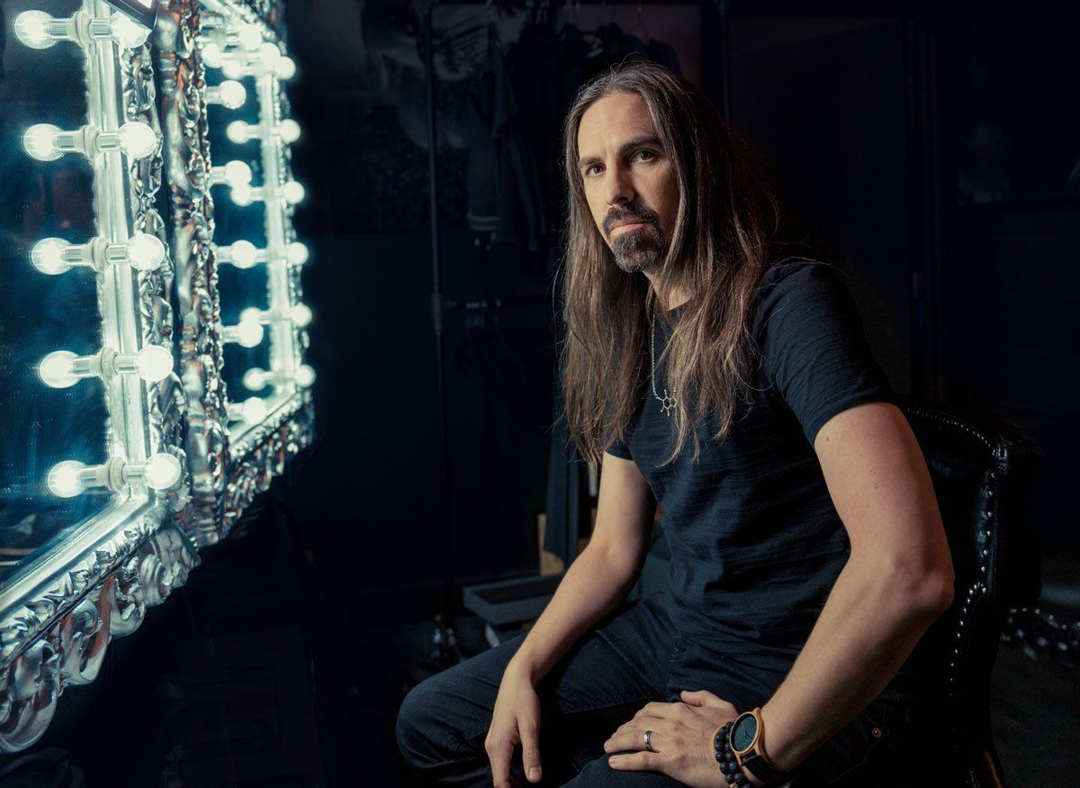 Composer Bear McCreary sits in front of an old fashioned Hollywood makeup mirror.